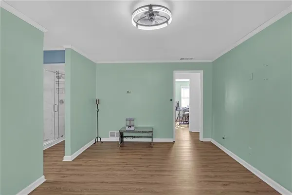 a view of a hallway with wooden floor