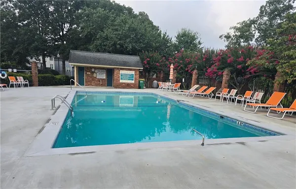 a view of a house with a yard and sitting area