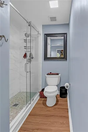 a bathroom with a toilet and a shower