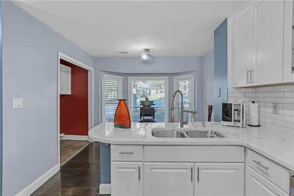 a kitchen with sink and window