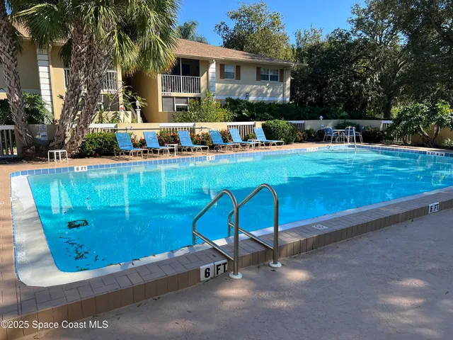 a view of a swimming pool with a lounge chairs