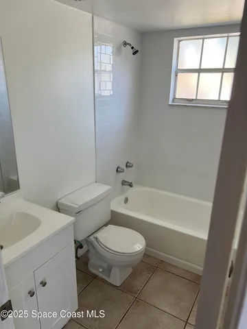 a white toilet sitting next to a bath tub shower