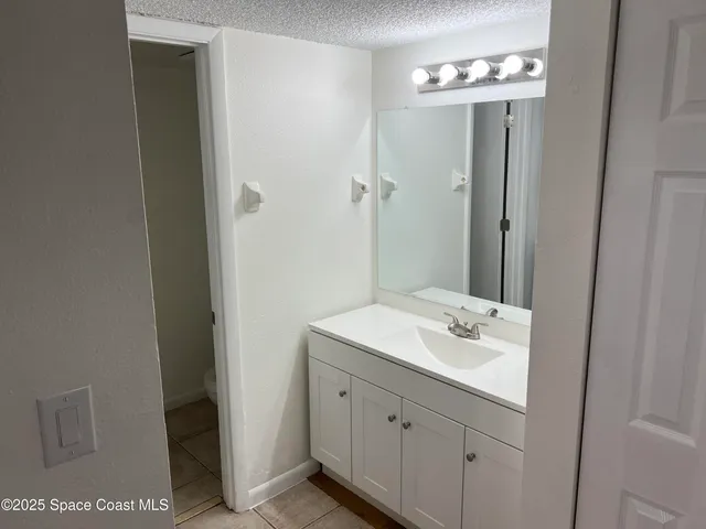 a bathroom with a sink a mirror and a shower