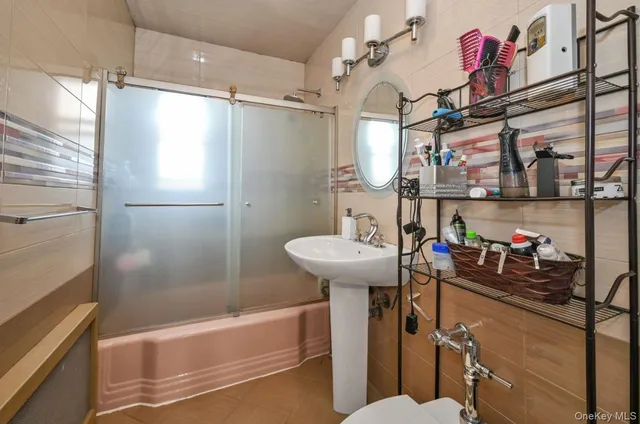 a bathroom with a sink mirror toilet and bathtub