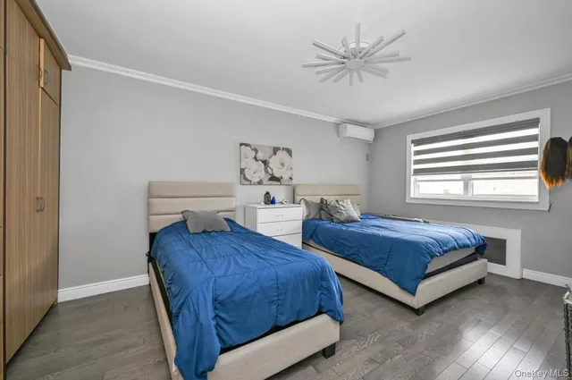 a bedroom with two beds and window