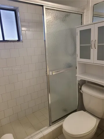a bathroom with a glass shower door