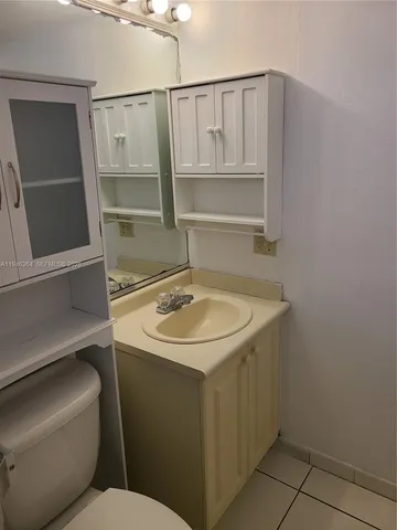 a bathroom with a sink toilet and vanity