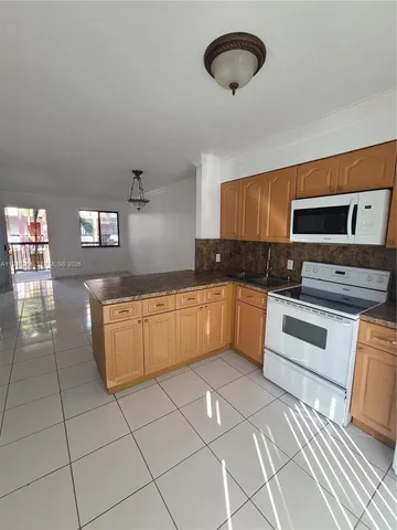 a kitchen with stainless steel appliances granite countertop a stove a sink and a granite counter tops
