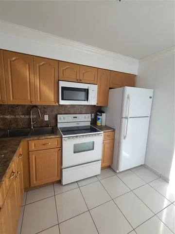 a kitchen with a refrigerator stove and microwave
