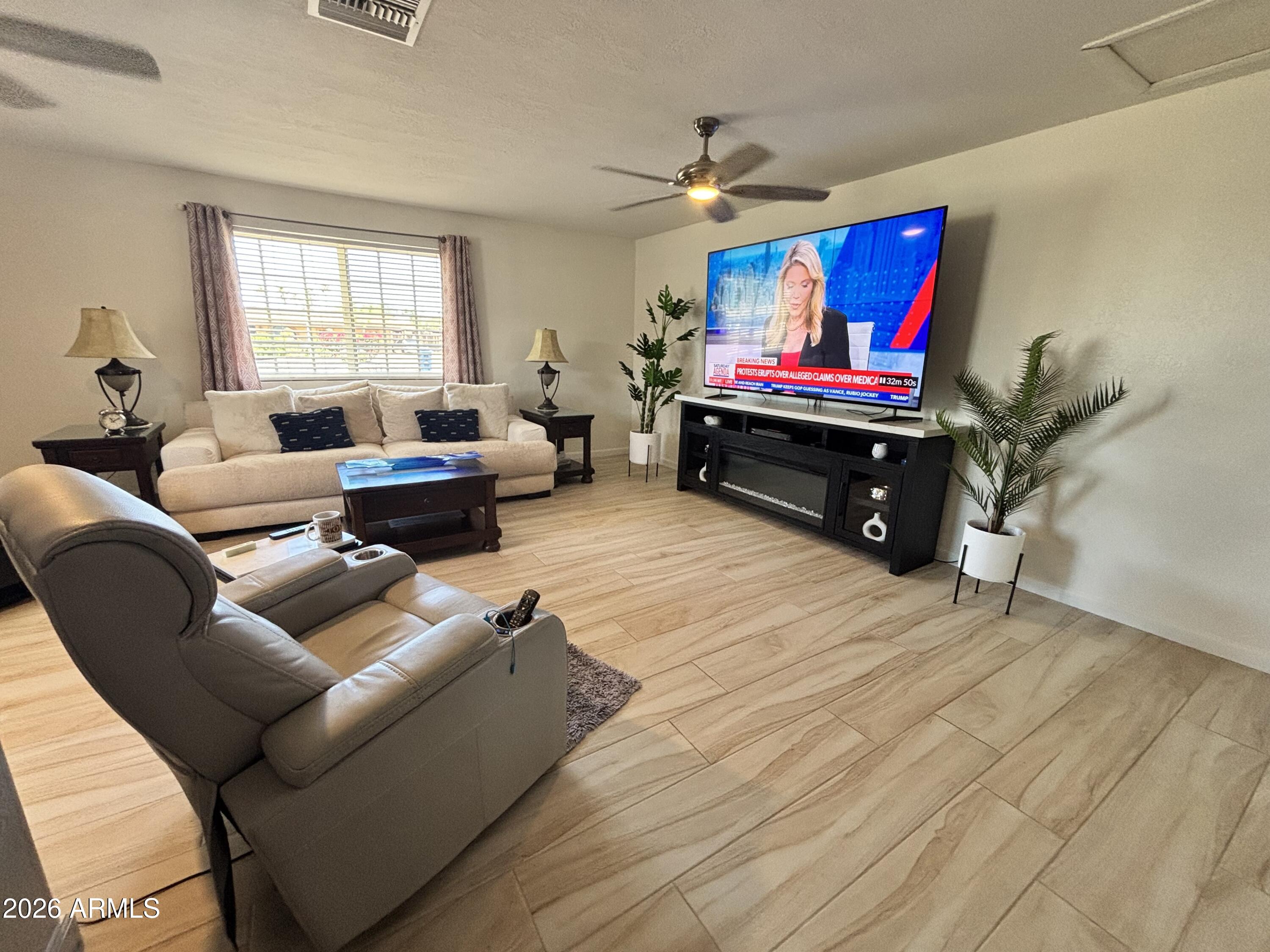 7745 East Mangun Road Mesa, AZ 85207 - Photo 24 of 35 a living room with furniture a rug and a window