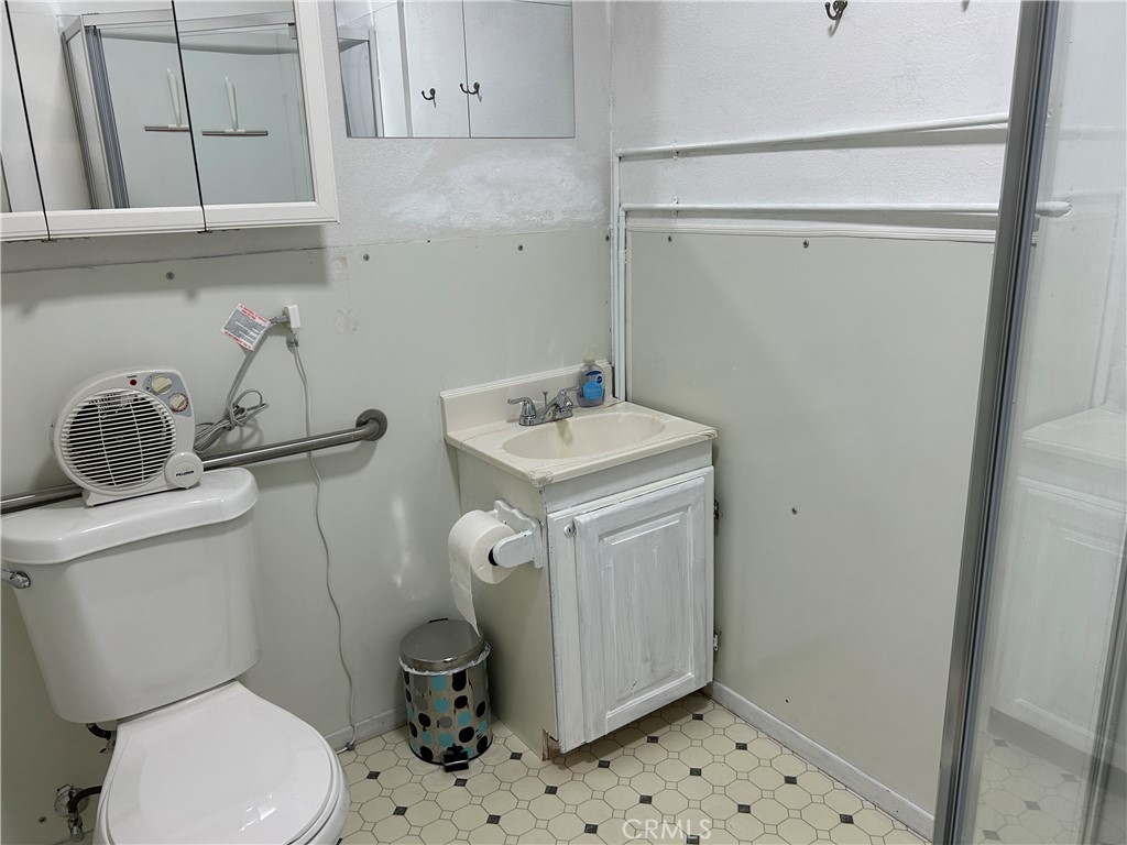 7025 Cuddy Valley Road, Unit F & H Frazier Park, CA 93225 - Photo 8 of 14 a bathroom with a sink a toilet and a mirror