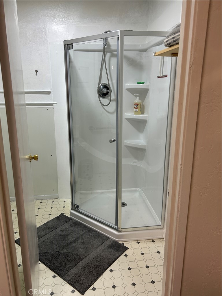7025 Cuddy Valley Road, Unit F & H Frazier Park, CA 93225 - Photo 9 of 14 a bathroom with a glass shower door