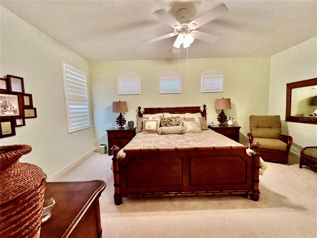 3304 Sunset Key Circle, Unit D Punta Gorda, FL 33955 - Photo 23 of 53 a bedroom with a bed and a chandelier