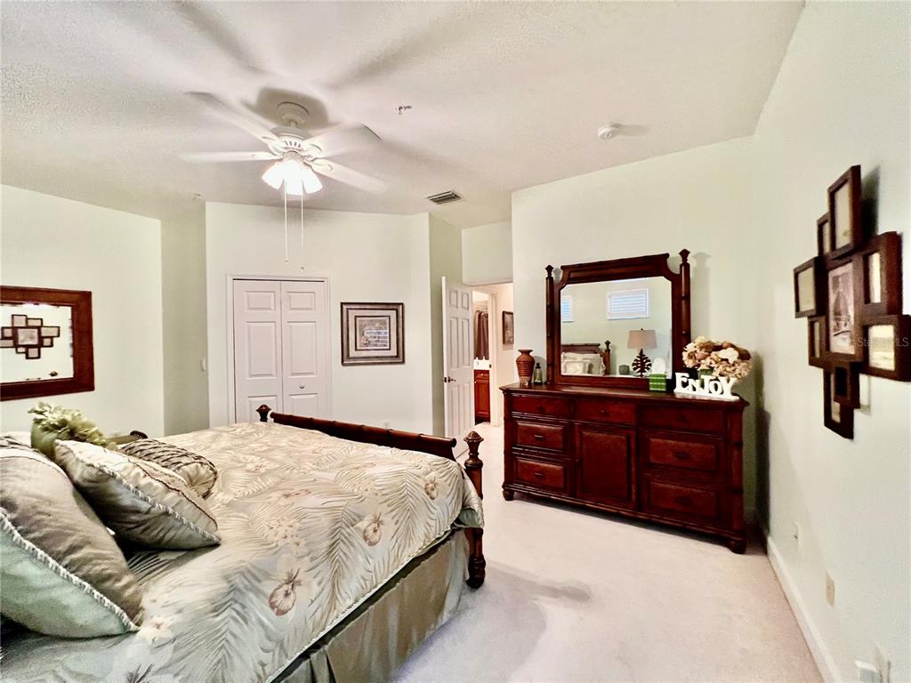 3304 Sunset Key Circle, Unit D Punta Gorda, FL 33955 - Photo 24 of 53 a bedroom with a bed and a mirror on the dresser