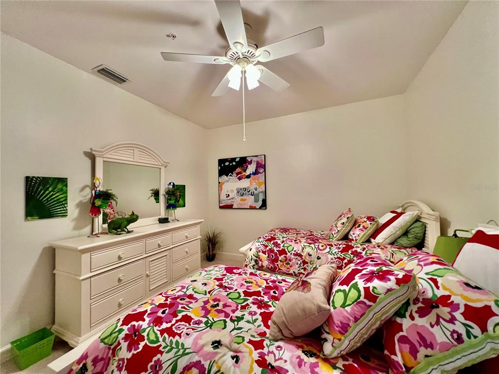 3304 Sunset Key Circle, Unit D Punta Gorda, FL 33955 - Photo 27 of 53 a bedroom with a bed and a dresser in it