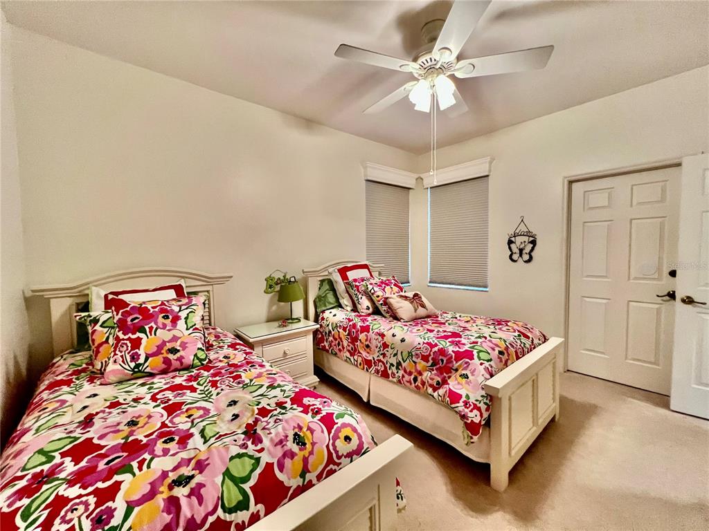 3304 Sunset Key Circle, Unit D Punta Gorda, FL 33955 - Photo 28 of 53 a bedroom with two beds and a chandelier