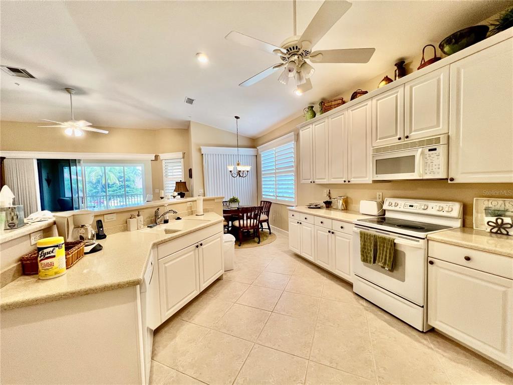 3304 Sunset Key Circle, Unit D Punta Gorda, FL 33955 - Photo 10 of 53 a large white kitchen with stainless steel appliances lots of white cabinets