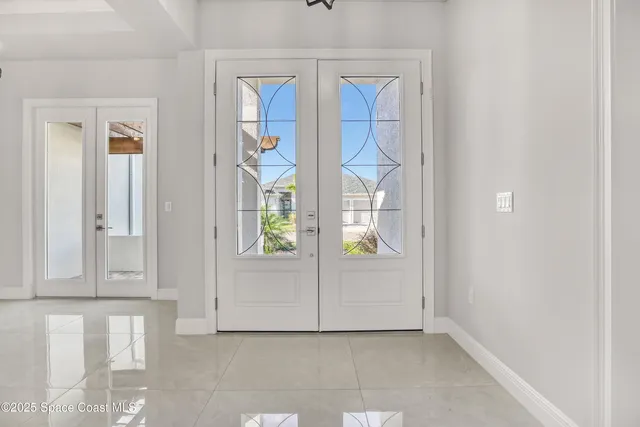 an entryway with a cabinet and mirror