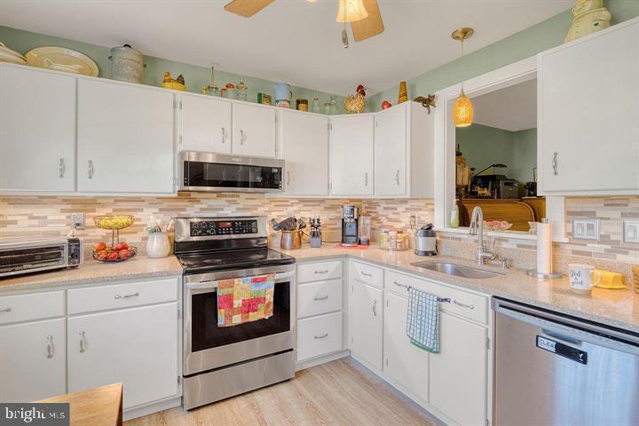 15-4 Cranberry Ridge Reading, PA 19606 - Photo 3 of 19 a kitchen with granite countertop a stove top oven sink and cabinets