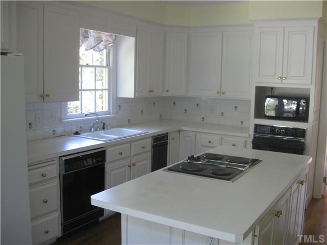 1429 Dogwood Lane Raleigh, NC 27607 - Photo 3 of 8 a kitchen with a sink a stove and cabinets