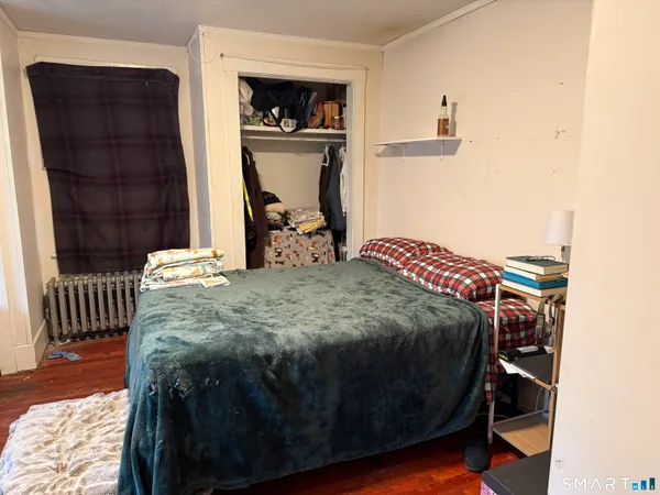 a bed sitting in a bedroom next to a small yard
