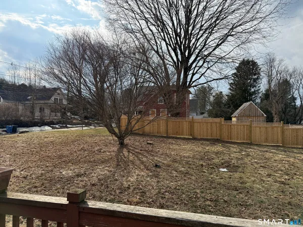 a view of a yard covered with snow in front of house