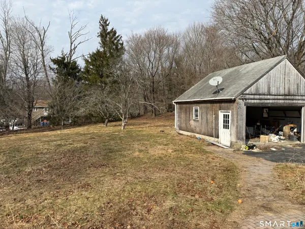 a view of a house with a yard covered in snow