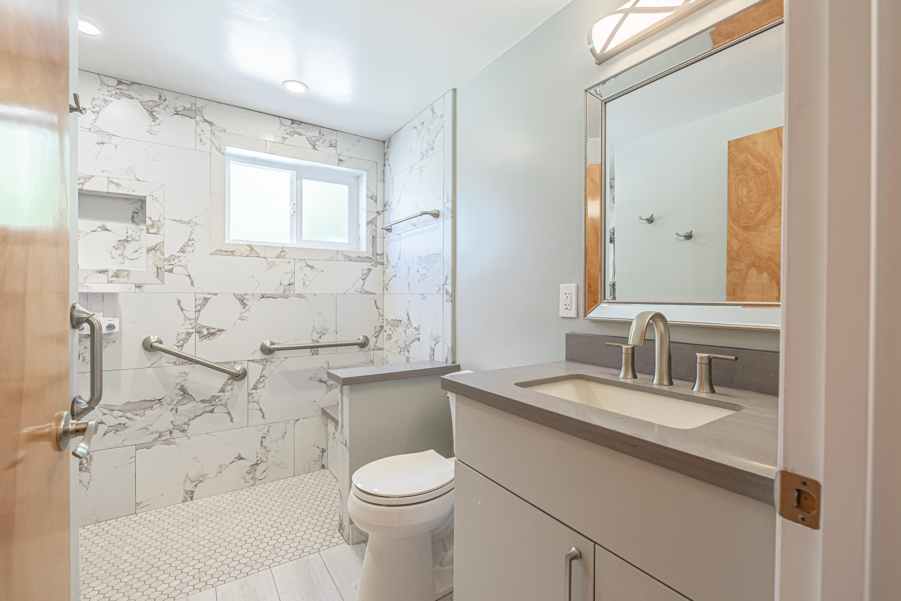 43733 Fenner Avenue Lancaster, CA 93536 - Photo 11 of 48 a bathroom with a granite countertop sink a toilet and shower