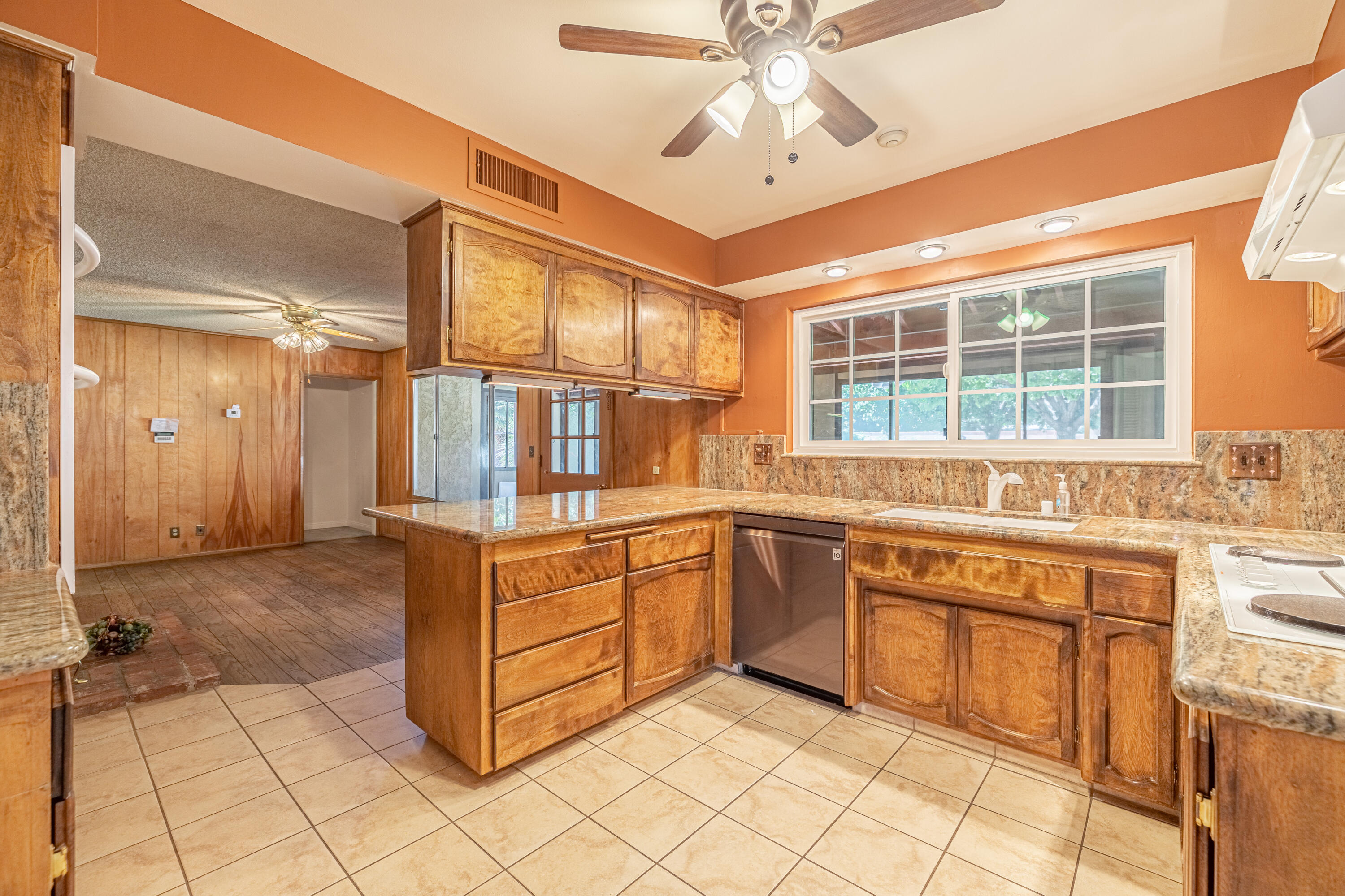 43733 Fenner Avenue Lancaster, CA 93536 - Photo 22 of 48 a kitchen with stainless steel appliances granite countertop a stove and a sink