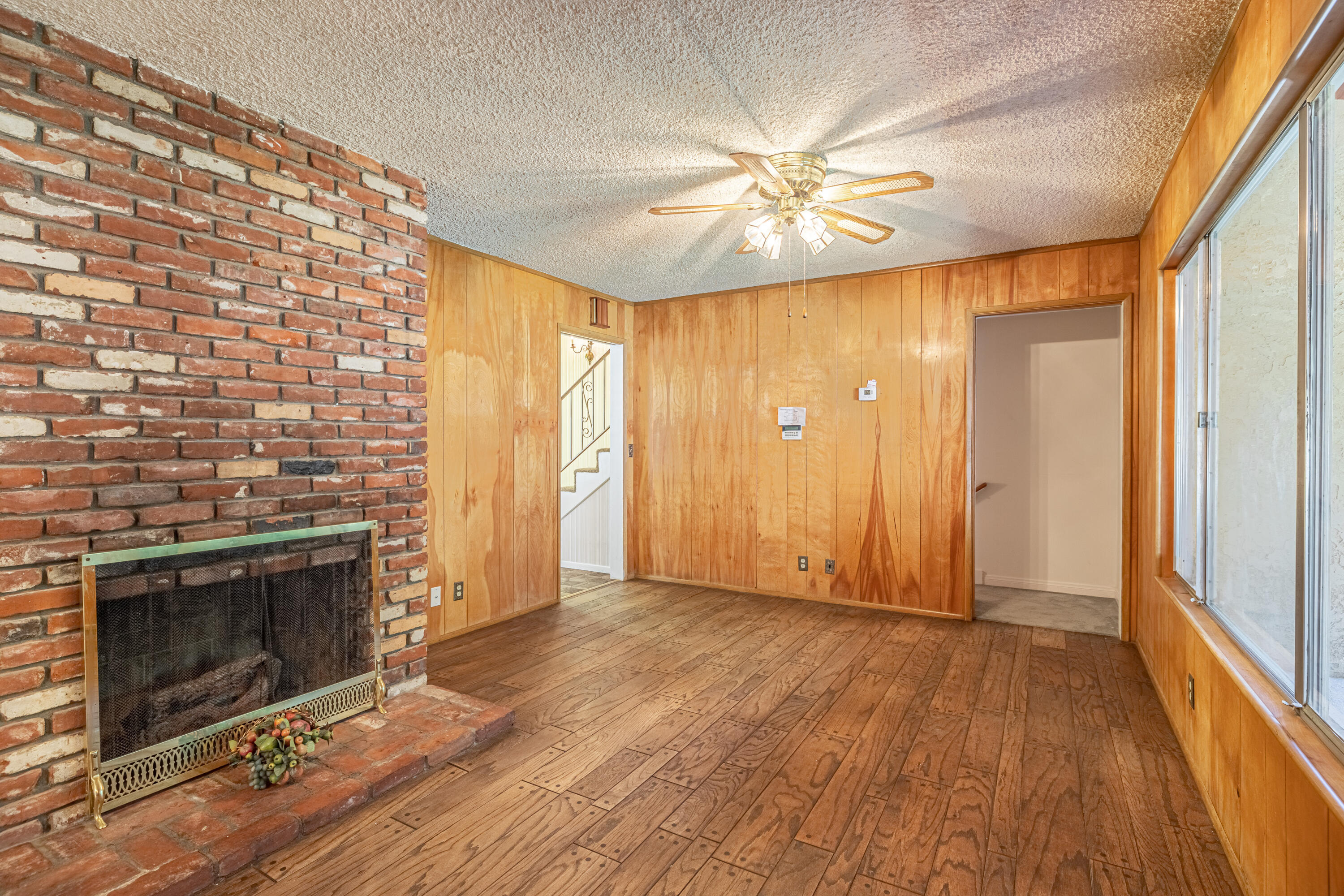 43733 Fenner Avenue Lancaster, CA 93536 - Photo 23 of 48 wooden floor in an empty room with a fireplace
