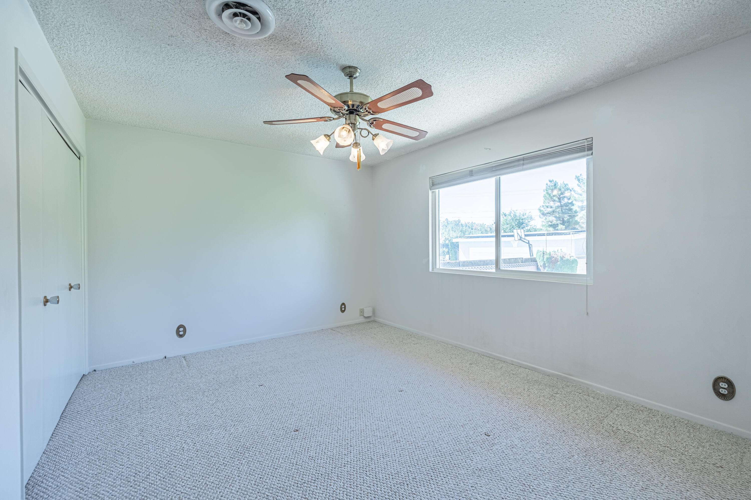 43733 Fenner Avenue Lancaster, CA 93536 - Photo 33 of 48 an empty room with a window and a fan