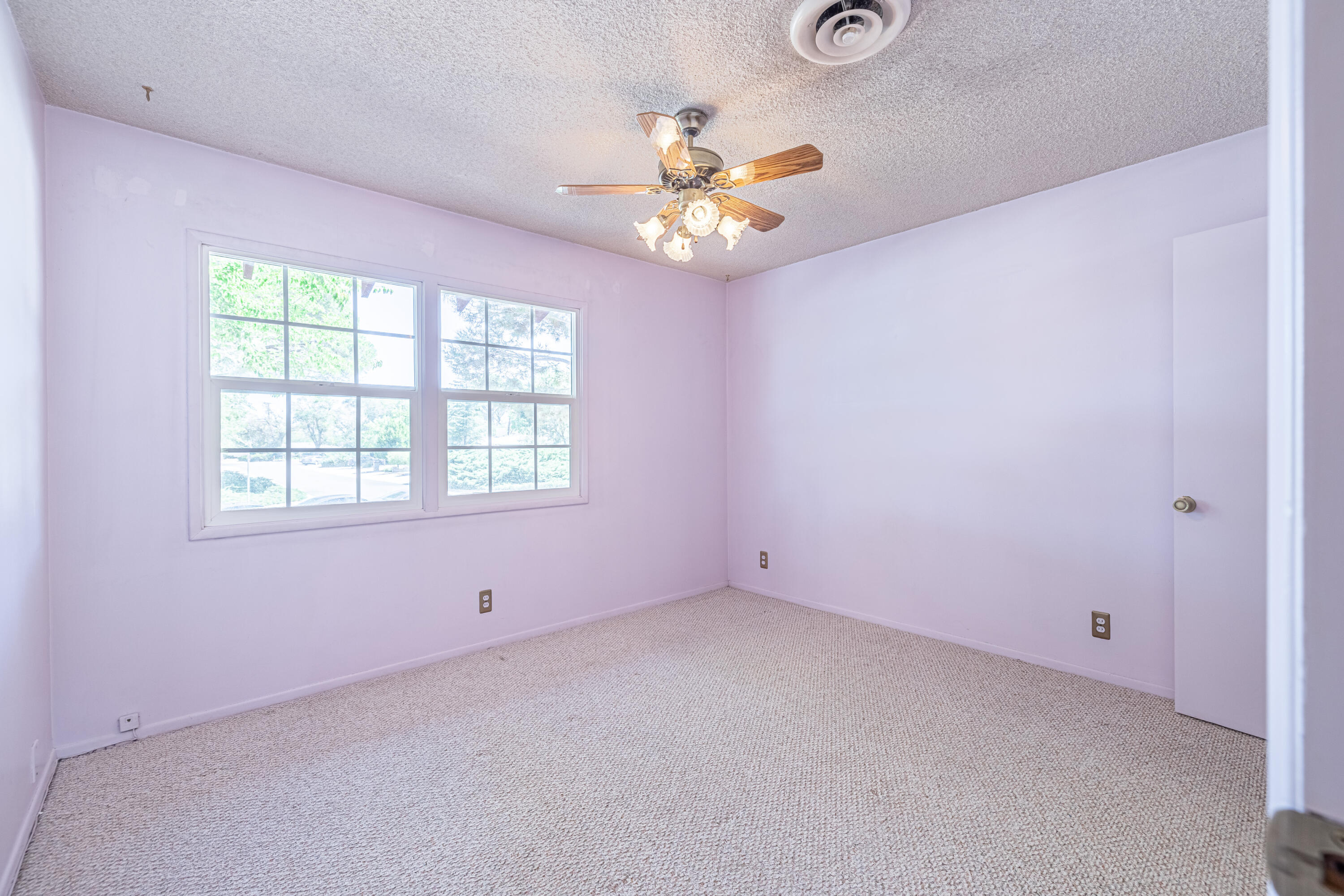 43733 Fenner Avenue Lancaster, CA 93536 - Photo 34 of 48 an empty room with a window and a ceiling fan
