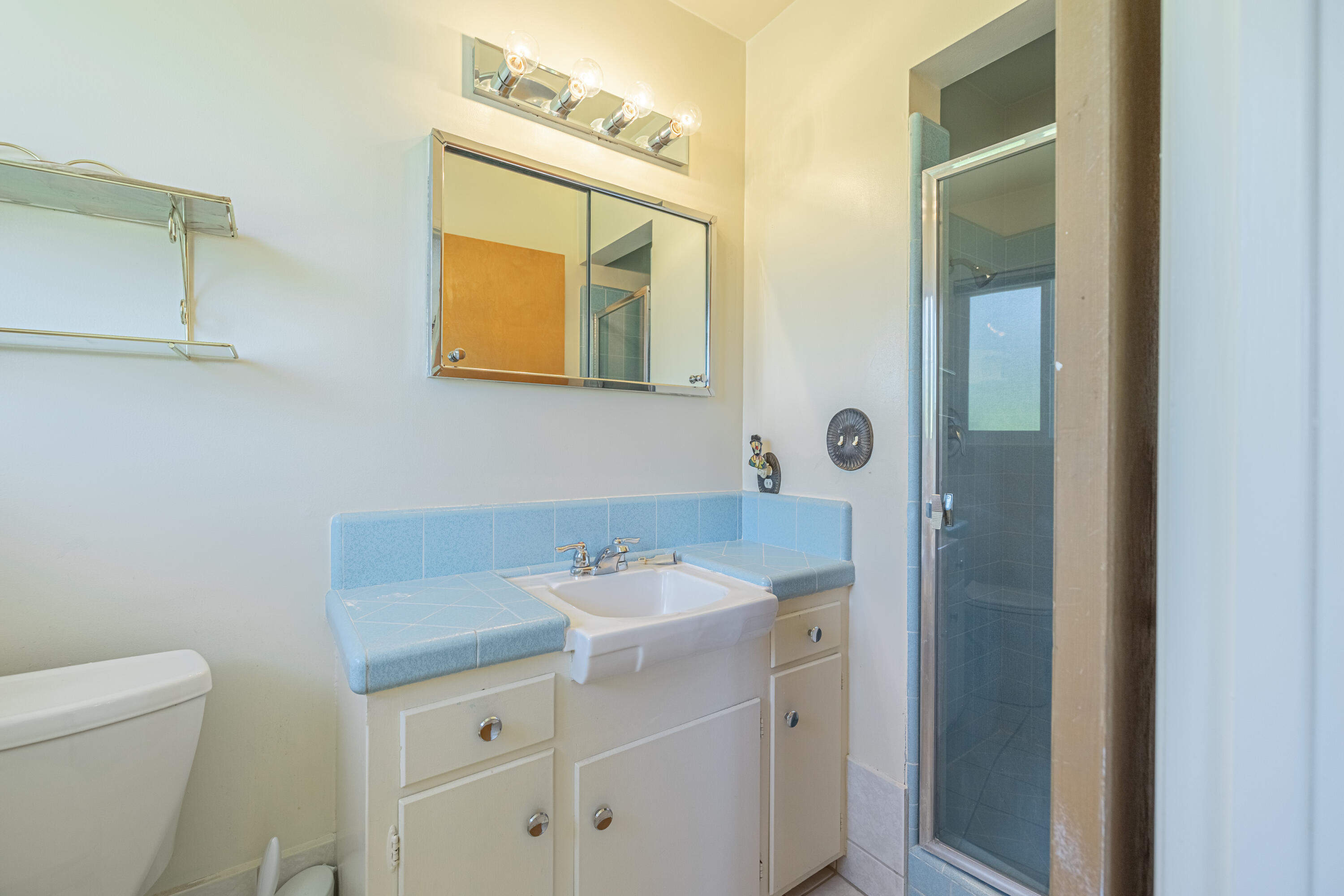 43733 Fenner Avenue Lancaster, CA 93536 - Photo 35 of 48 a bathroom with a sink a toilet and mirror