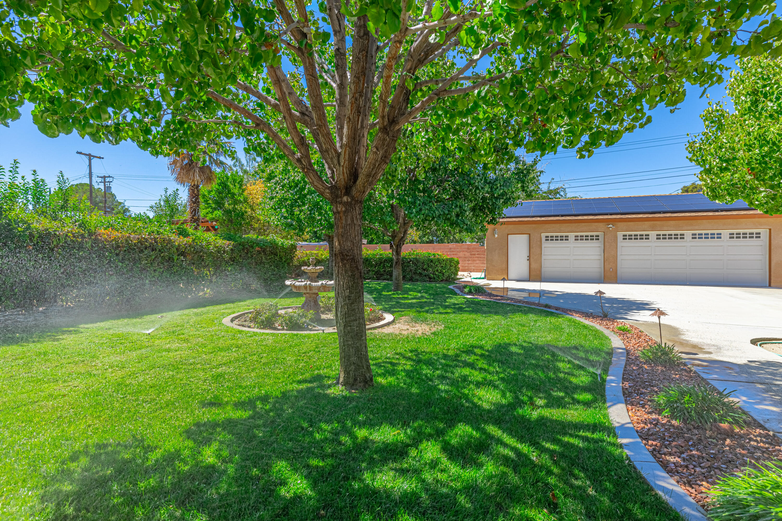 43733 Fenner Avenue Lancaster, CA 93536 - Photo 4 of 48 a front view of a house with garden and lake view