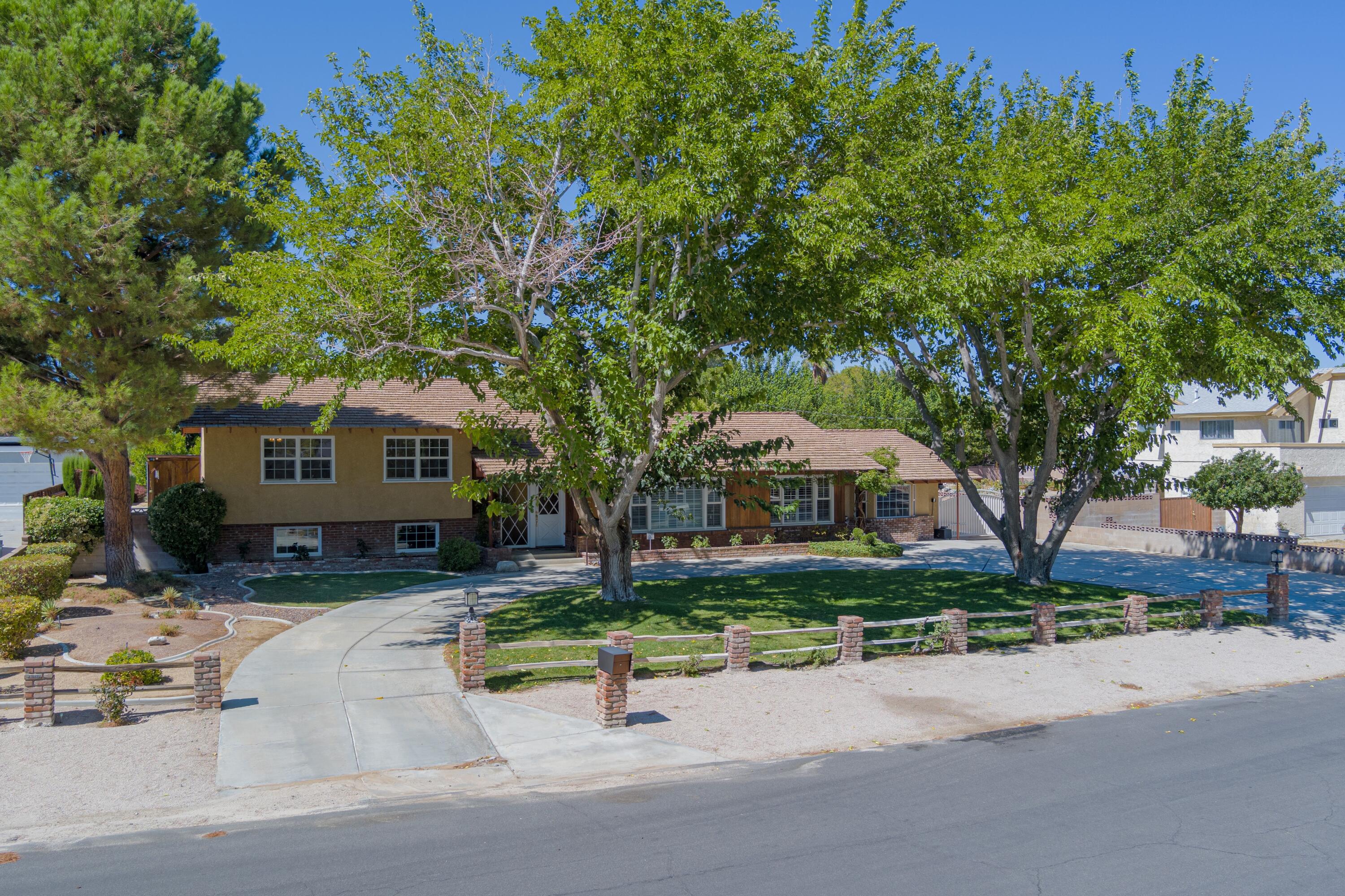 43733 Fenner Avenue Lancaster, CA 93536 - Photo 48 of 48 a front view of a house with a yard