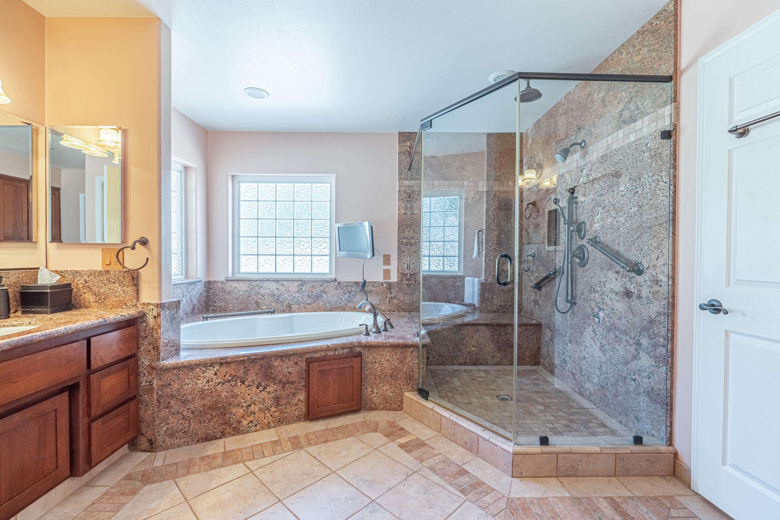 43733 Fenner Avenue Lancaster, CA 93536 - Photo 7 of 48 a spacious bathroom with a granite countertop tub shower sink and mirror