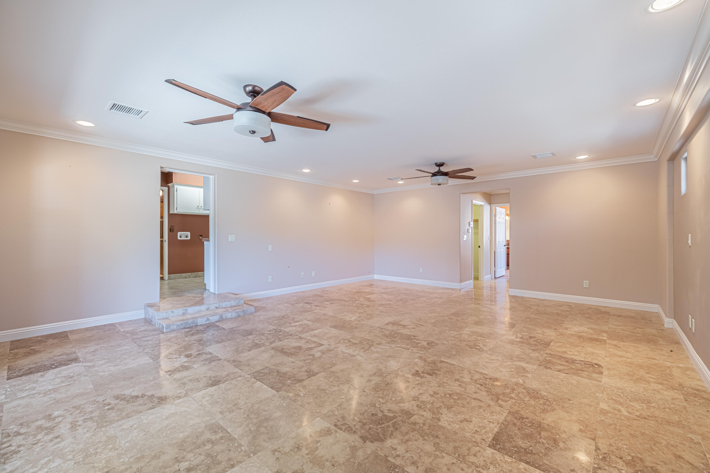 43733 Fenner Avenue Lancaster, CA 93536 - Photo 8 of 48 an empty room with a ceiling fan and a window