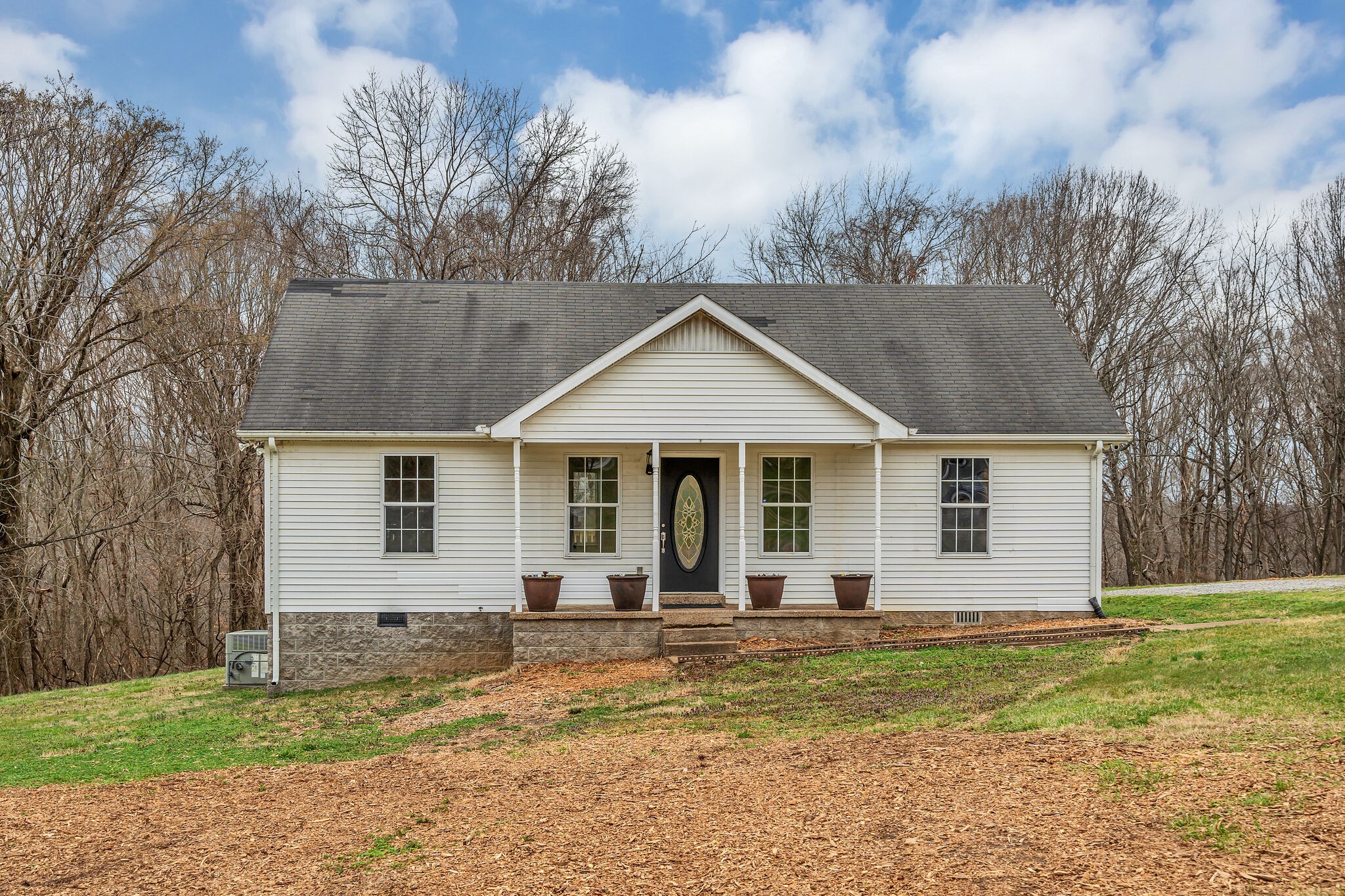 a front view of a house with a garden