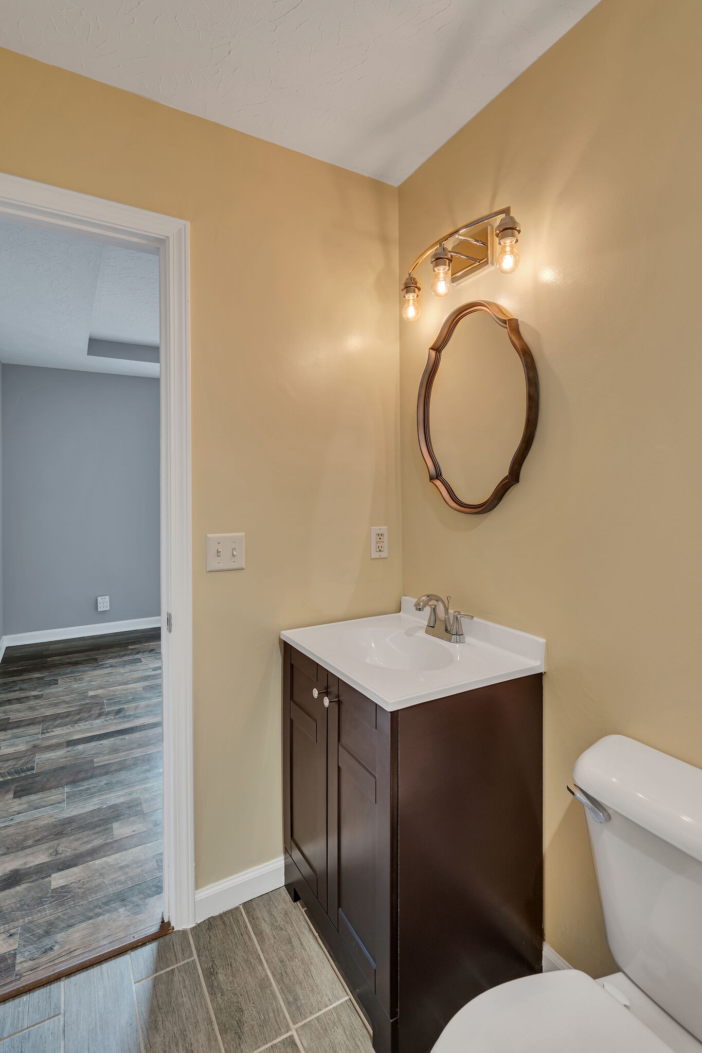 3716 Dobbin Road Springfield, TN 37172 - Photo 19 of 34 a bathroom with a toilet sink vanity and mirror