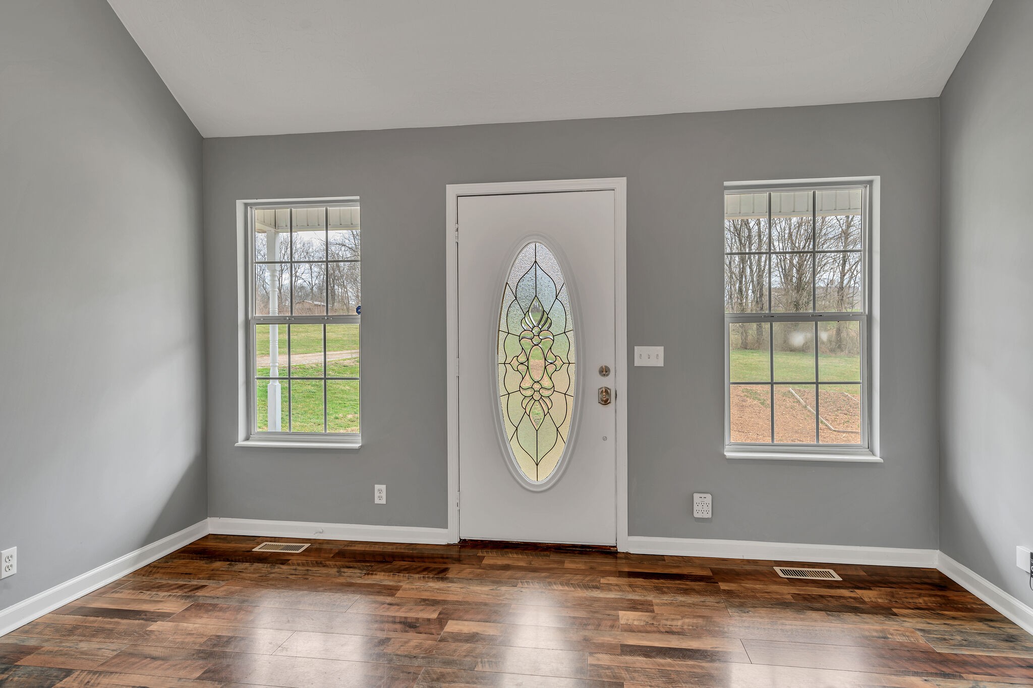 3716 Dobbin Road Springfield, TN 37172 - Photo 8 of 34 an empty room with window wooden floor and mirror