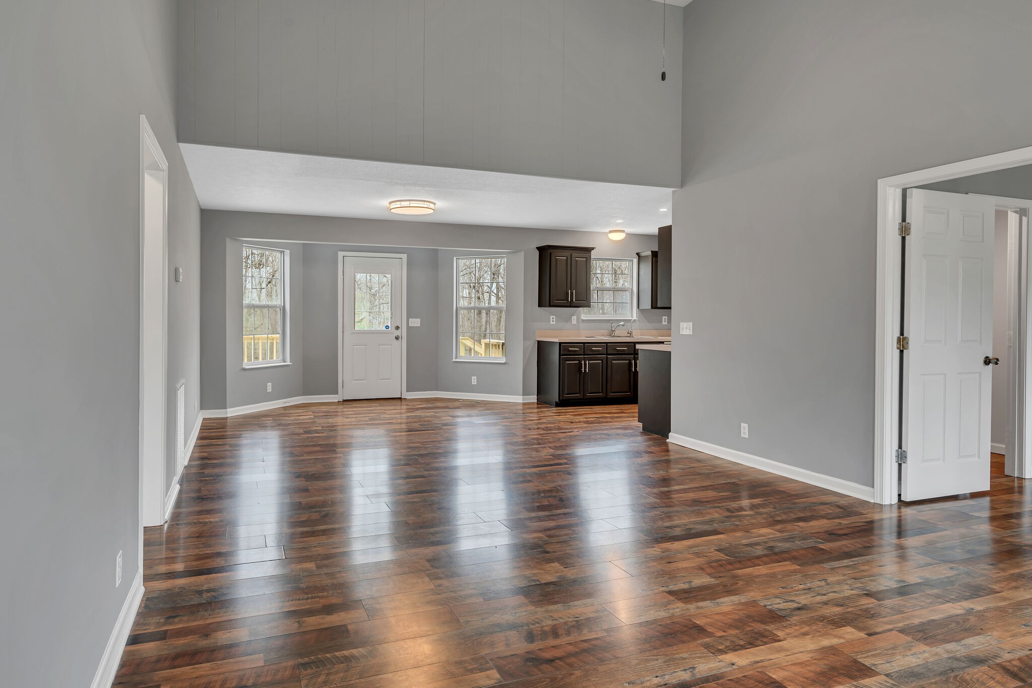 3716 Dobbin Road Springfield, TN 37172 - Photo 9 of 34 an empty room with wooden floor fireplace and windows