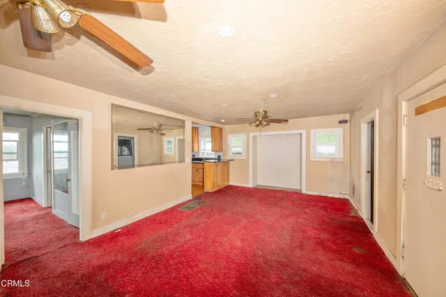 a big room with wooden floor and windows