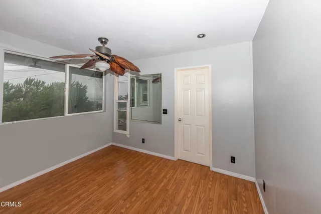 a view of a room with wooden floor and windows