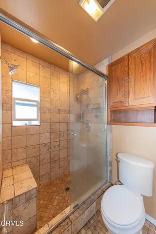 a white toilet sitting next to a bathroom sink