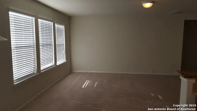 an empty room with windows and entrance