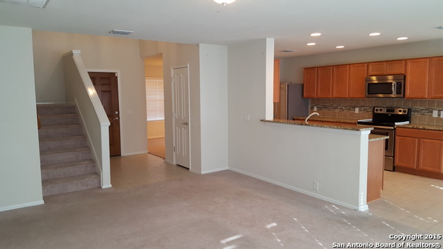 1332 Wagon Wheel Schertz, TX 78154 - Photo 12 of 21 a view of a kitchen with fridge and wooden floor