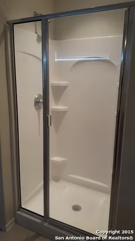 a bathroom with a glass shower door