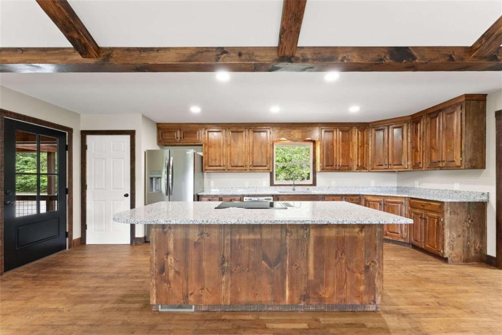 707 South Fern Cove Road Sautee Nacoochee, GA 30571 - Photo 15 of 60 a large kitchen with stainless steel appliances a large counter top and a wooden floors