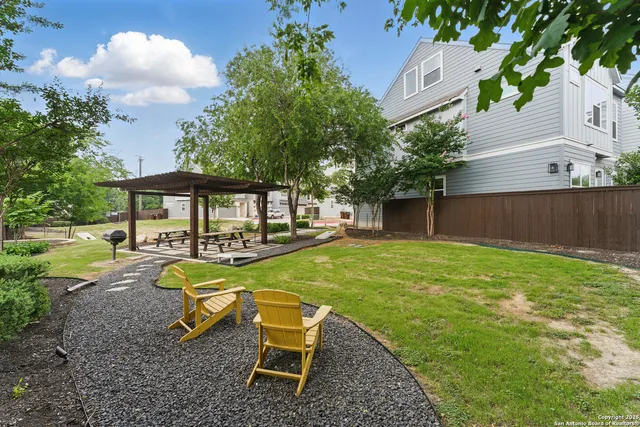 a view of a house with backyard porch and sitting area