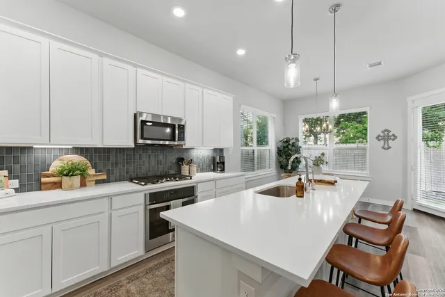 a kitchen with a stove a sink and a refrigerator